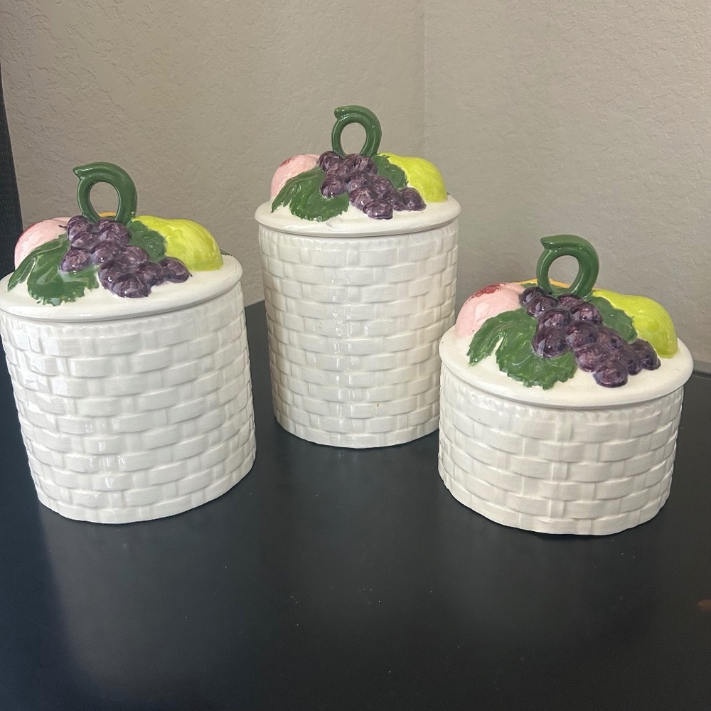 Vintage set of three ceramic fruit basket canisters.